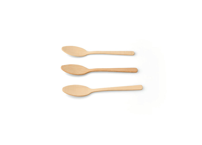 Three beige bamboo dessert spoons against a white background.