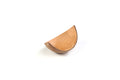 A beige, wave-shaped, disposable serving boat made of eco-friendly materials, isolated on a white background.