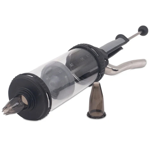 A pressure syringe with a clear container, metallic parts and black rubber components, alongside two nozzle attachments.