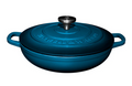 Blue cast iron cookware with lid on a white background