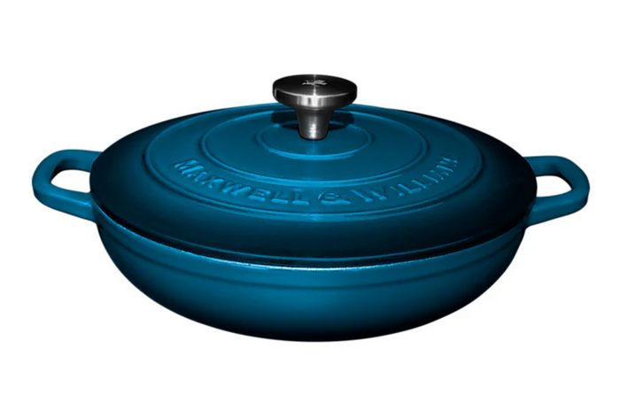 Blue cast iron cookware with lid on a white background