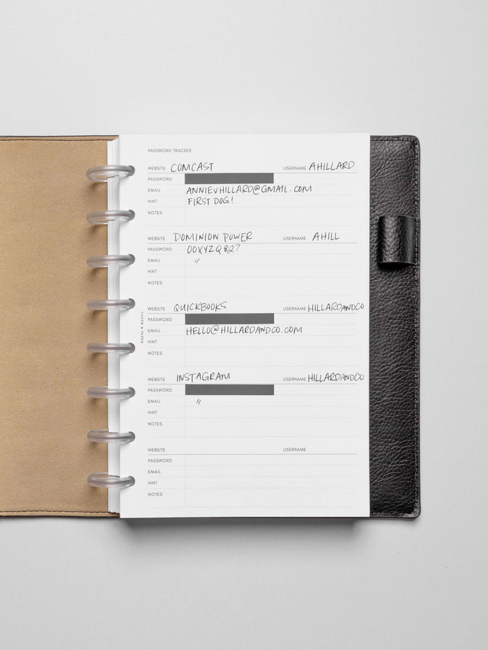 Insert in use inside a black leather planner. Page pins have been used to block out the password field, and the rest of the insert is filled out in pen.